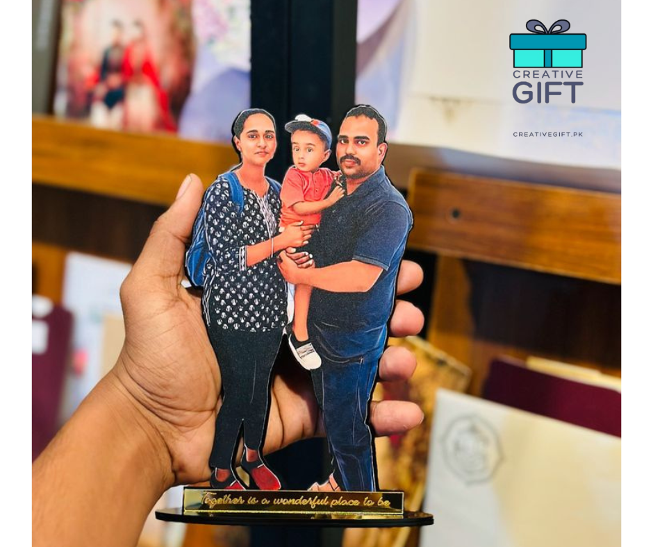 Hand holding a custom family photo standee of a man, woman, and child with Creativegift.pk logo