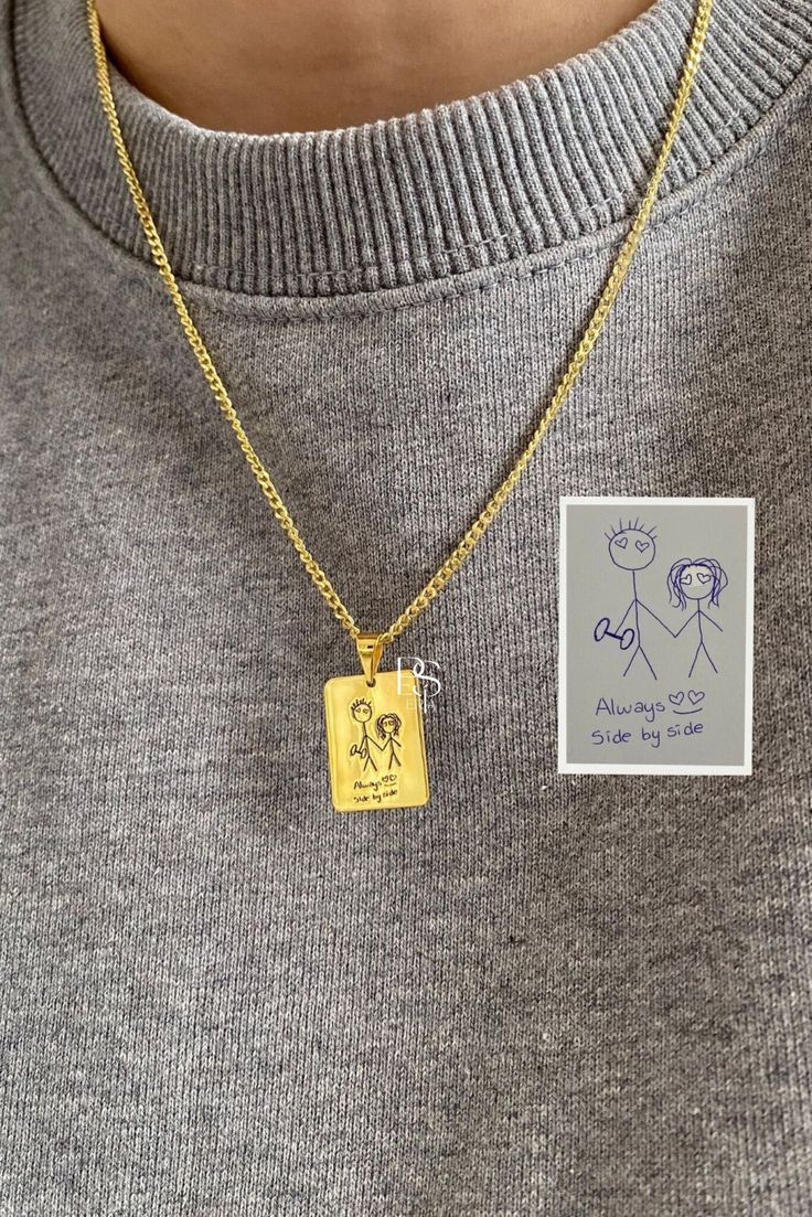 Gold custom handwriting necklace with a rectangular pendant featuring a child's drawing and text Always side by side