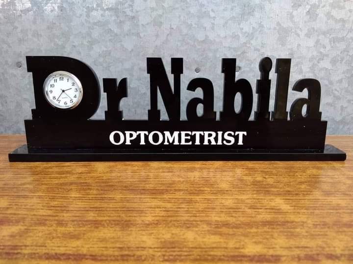 Doctor name desk clock with Dr Nabila name and optometrist title in black wooden design