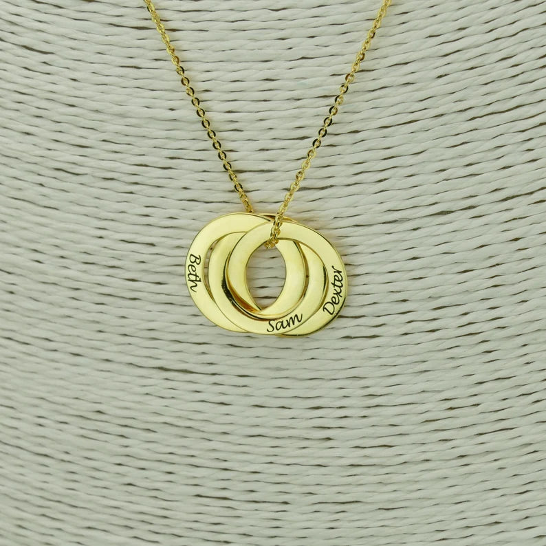 Gold personalized mom necklace with kids names engraved on three interlocking rings