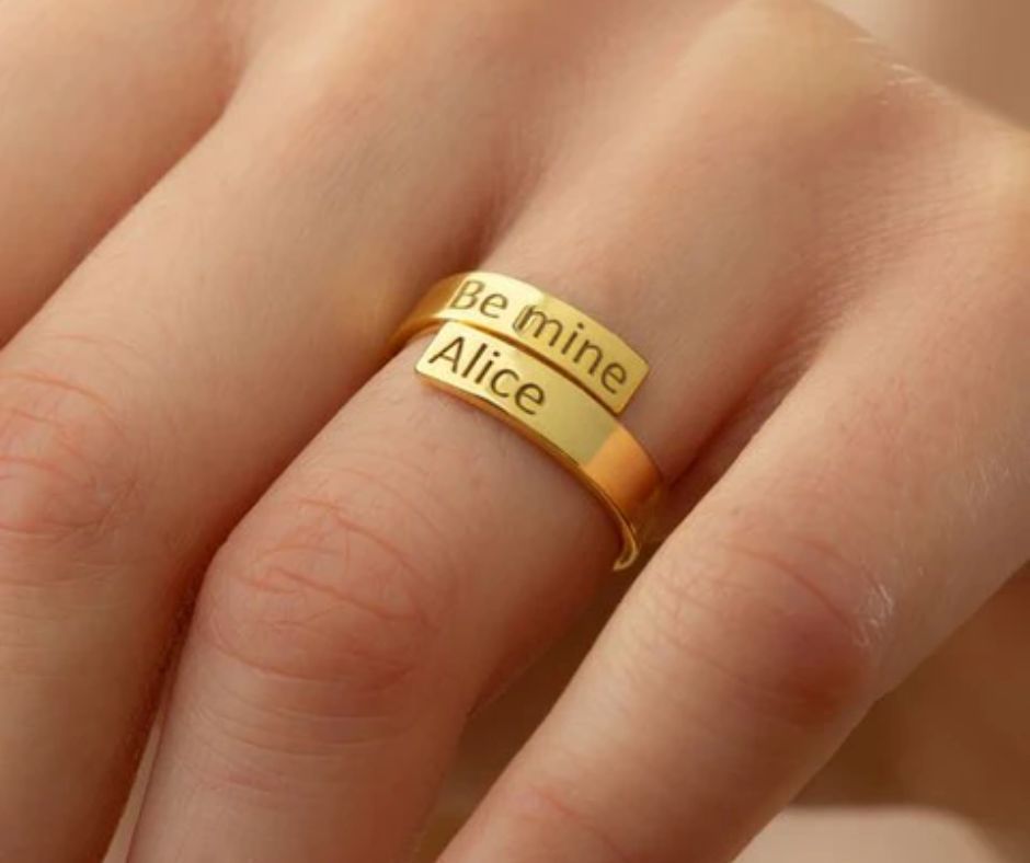 Gold personalized name ring for couples with engraved text Be mine and Alice on finger