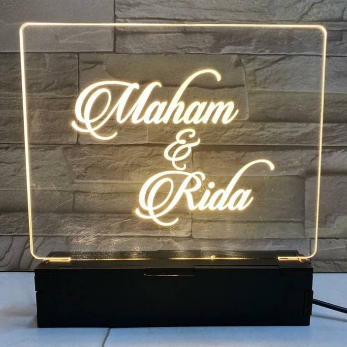 Personalized name LED lamp displaying names Maham and Rida with elegant script font on clear panel