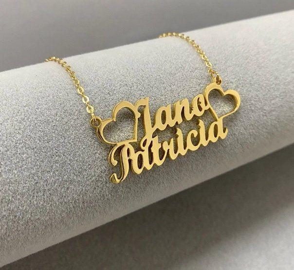 Gold personalized name necklace with Jane Patricia design and heart shapes on delicate chain
