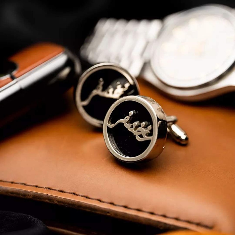 Elegant custom cufflinks and studs with personalized name design on black background with watch and wallet