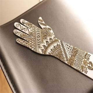 Artificial mehndi practice hand with intricate henna design patterns for mehndi artists