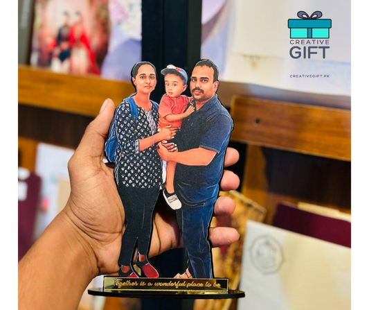Hand holding a custom family photo standee of a man, woman, and child with Creativegift.pk logo