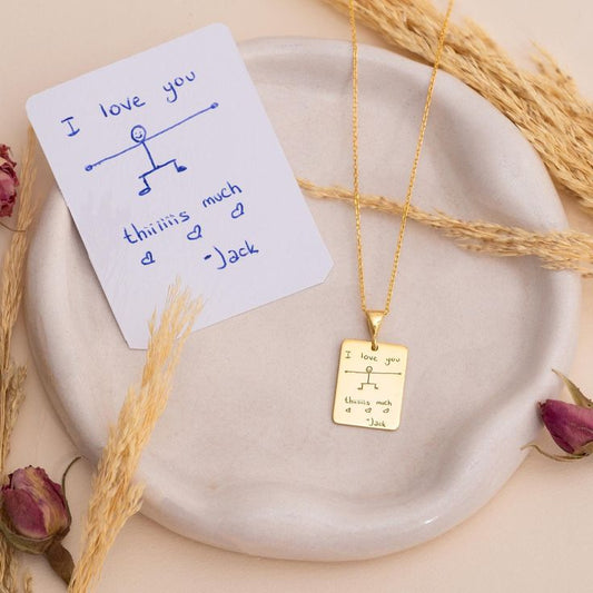 Gold custom handwriting necklace engraved with a handwritten note and drawing on a rectangular pendant