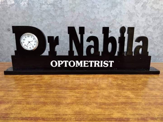 Doctor name desk clock with Dr Nabila name and optometrist title in black wooden design