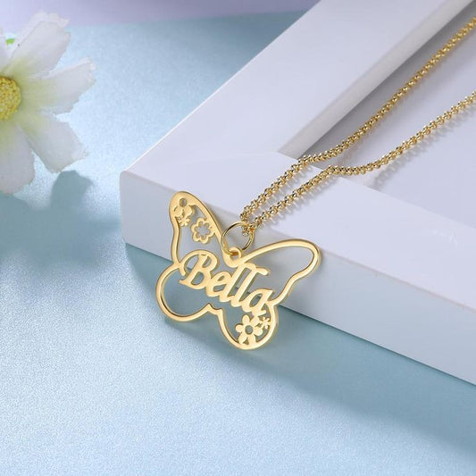 Gold custom butterfly name necklace with Bella name and floral cutout design on gold chain