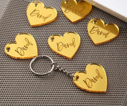 Gold personalized heart keychain with the name David engraved on multiple keychains
