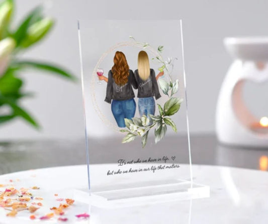 Personalized acrylic plaque for best friend featuring two women with jackets and floral design on clear stand