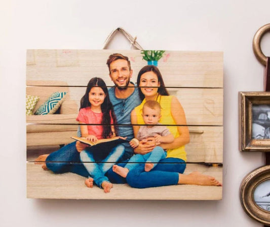 Unique family photo wood plaque hanging on wall showing smiling family of four sitting together indoors